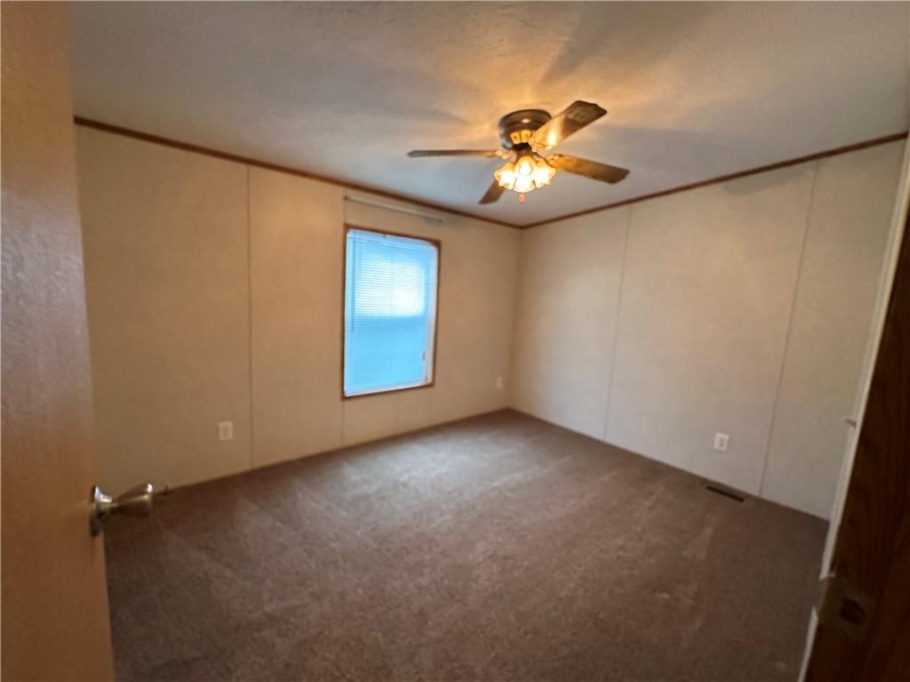 107 Trieste Street Butler, PA 16002 - Photo 31 of 40 en empty room with windows and ceiling fan