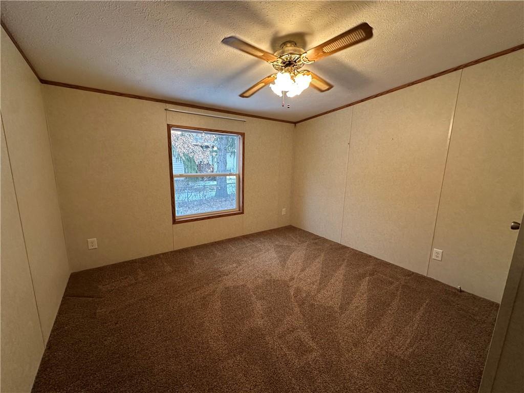 107 Trieste Street Butler, PA 16002 - Photo 33 of 40 an empty room with a chandelier fan and a window