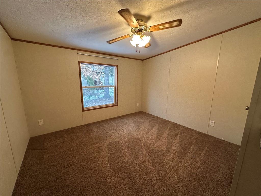 107 Trieste Street Butler, PA 16002 - Photo 34 of 40 an empty room with a chandelier fan and windows
