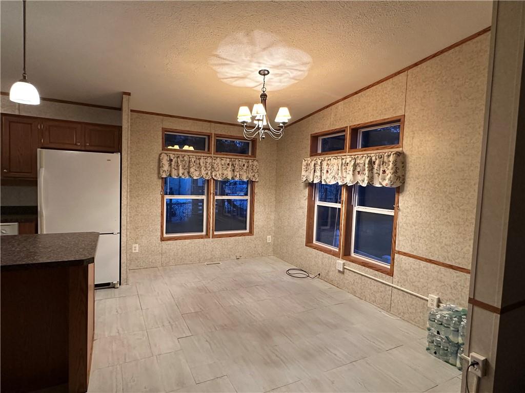 107 Trieste Street Butler, PA 16002 - Photo 7 of 40 a view of a room with a chandelier and fireplace