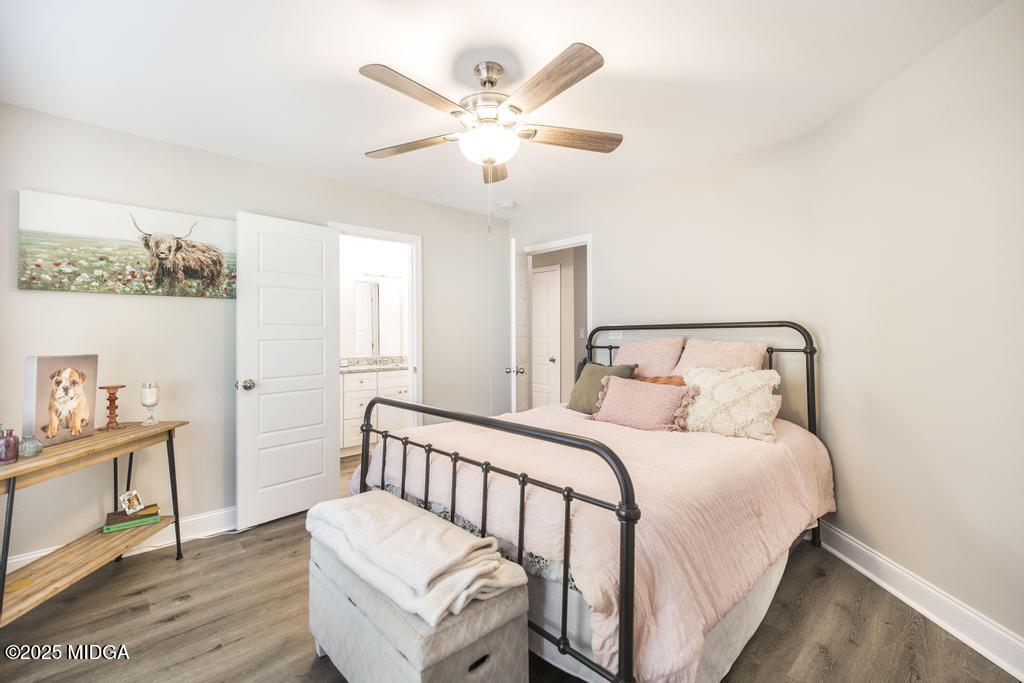 219 Diamond Place Gray, GA 31032 - Photo 11 of 42 a bedroom with a bed and a chandelier