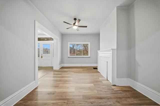 wooden floor in an empty room with a window