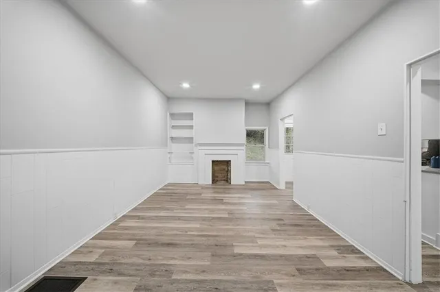 a view of a livingroom with an empty space and a fireplace