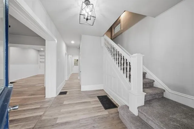 a view of entryway and hall with wooden floor