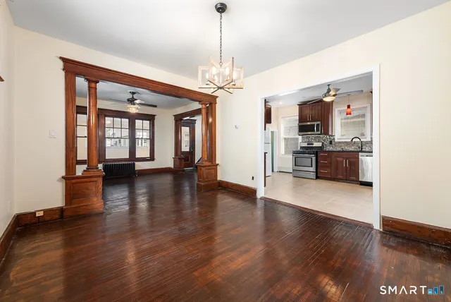 a view of a livingroom with furniture hardwood floor and a ceiling fan