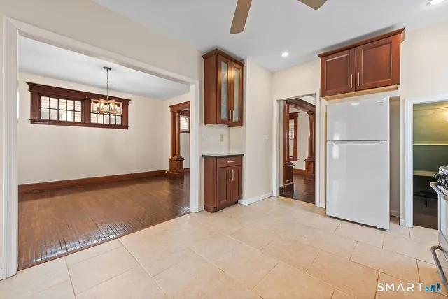 a view of a kitchen with an empty space and wooden floor