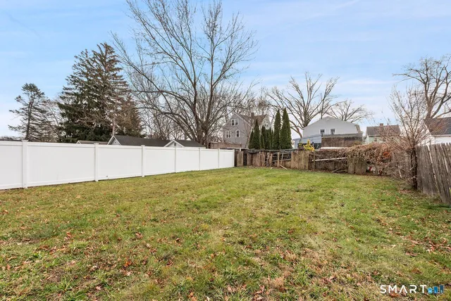 a wooden bench sitting in front of a building