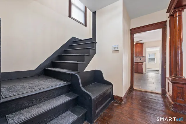 a view of entryway and hall with wooden floor