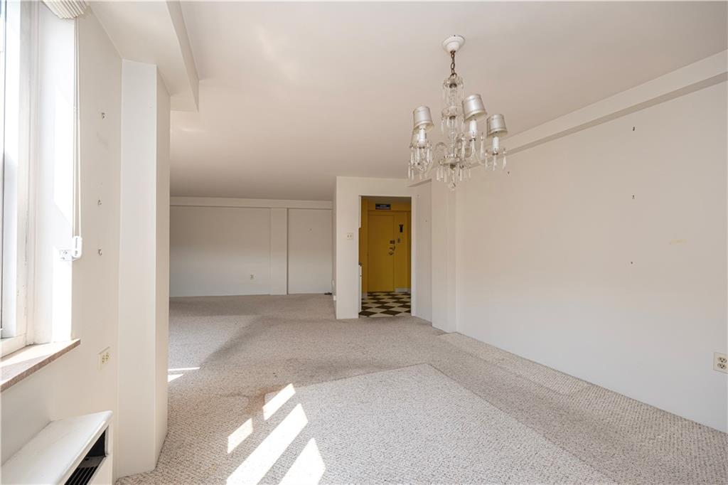 4625 Fifth Avenue, Unit 609 Pittsburgh, PA 15213 - Photo 15 of 27 a view of a chandelier in big room and a bathroom