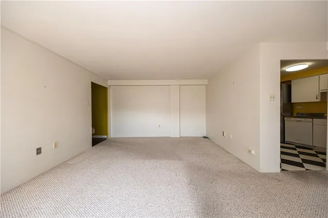 a kitchen with a sink a refrigerator and cabinets