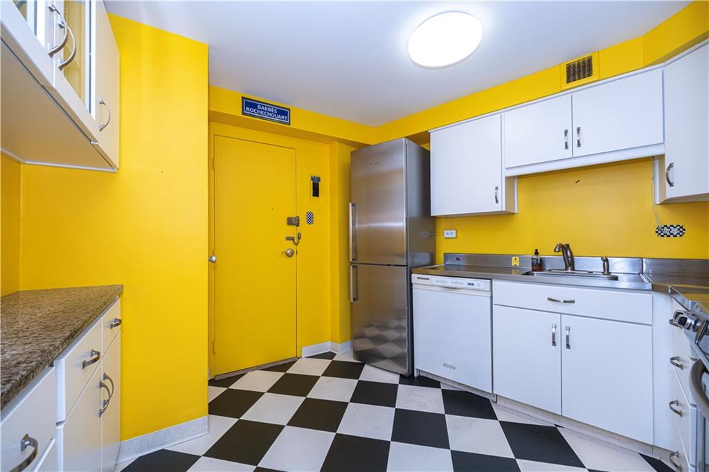 4625 Fifth Avenue, Unit 609 Pittsburgh, PA 15213 - Photo 18 of 27 a kitchen with a sink a refrigerator and cabinets