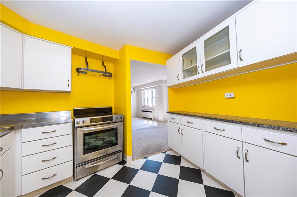 4625 Fifth Avenue, Unit 609 Pittsburgh, PA 15213 - Photo 19 of 27 a kitchen with a stove a sink and a cabinets