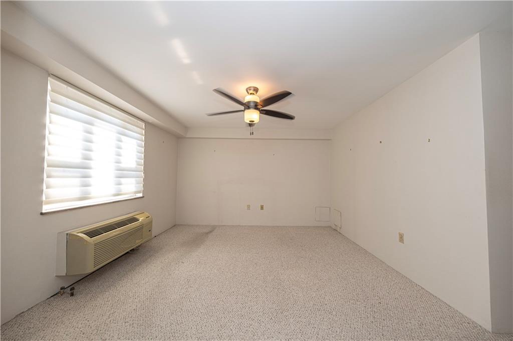 4625 Fifth Avenue, Unit 609 Pittsburgh, PA 15213 - Photo 23 of 27 an empty room with chandelier fan and windows