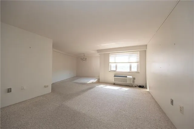 an empty room with kitchen view