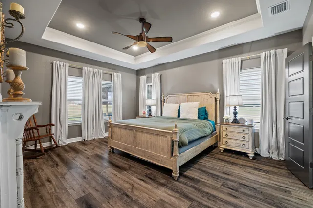 a bedroom with a large bed and a tv