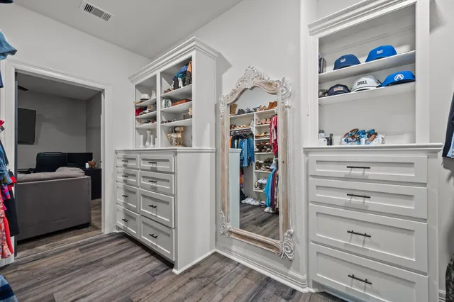 a living room with a bookshelf and a wooden floor