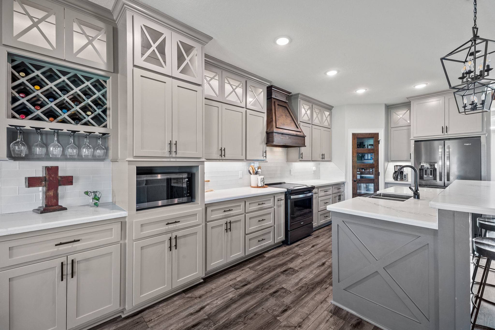 756 Angus Trail Angleton, TX 77515 - Photo 38 of 39 a kitchen with a sink dishwasher a stove and white cabinets with wooden floor