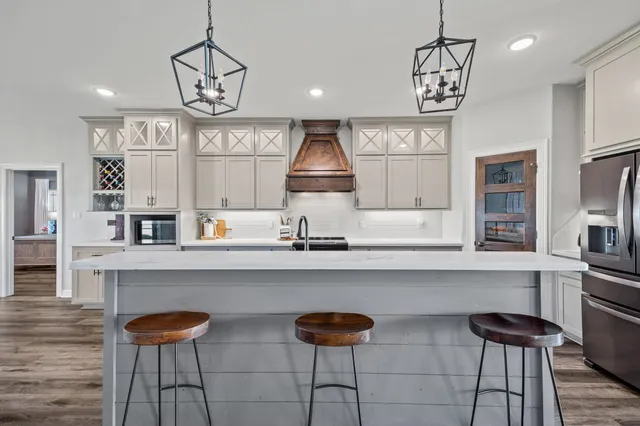 a kitchen with stainless steel appliances granite countertop a stove and cabinets