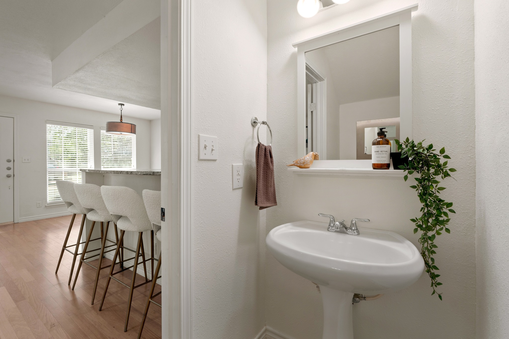 1504 Allen Road, Unit B Austin, TX 78746 - Photo 20 of 24 A classic pedestal sink and framed mirror accent this bright, functional half bath.