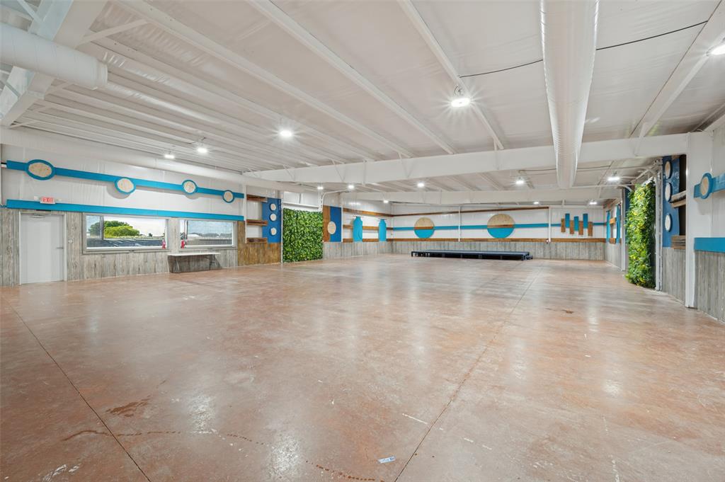 1601 East Blackjack Road East Pilot Point, TX 76258 - Photo 22 of 30 Spacious commercial interior featuring high ceilings, stained concrete flooring, recessed lighting, and expansive wall-mounted plant features