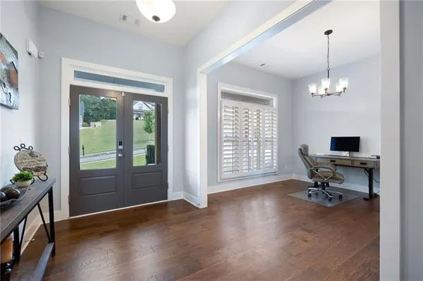 a view of a livingroom with workspace and a window