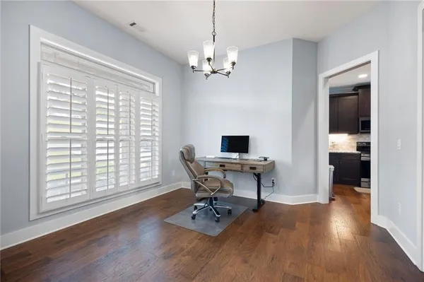 a view of a workspace with furniture and a window