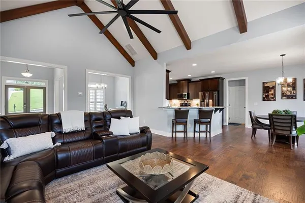 a living room with furniture and kitchen view