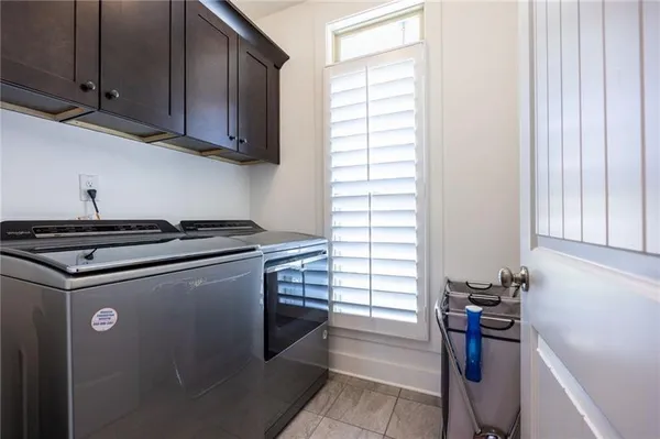 a view of a kitchen with a sink dryer and cabinets