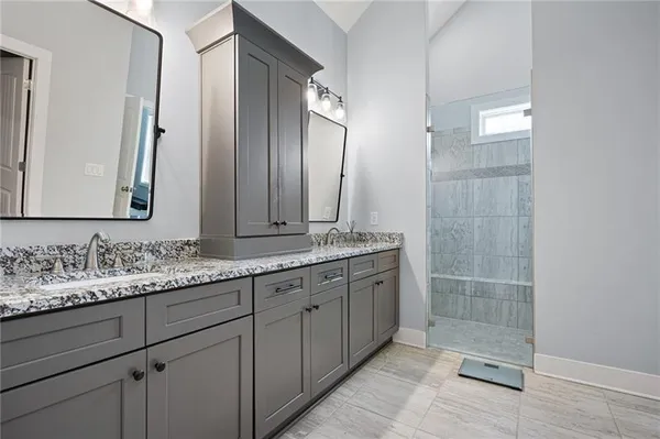 a bathroom with double sink and a mirror