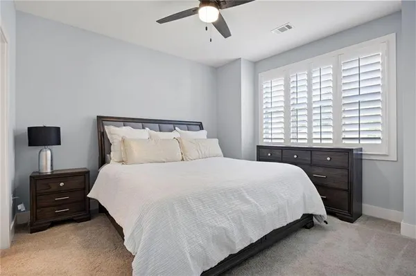 a bedroom with a bed and a tv