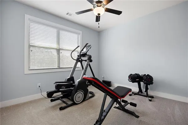 a room with gym equipment and windows
