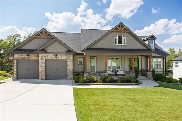 a front view of a house with swimming pool having outdoor seating