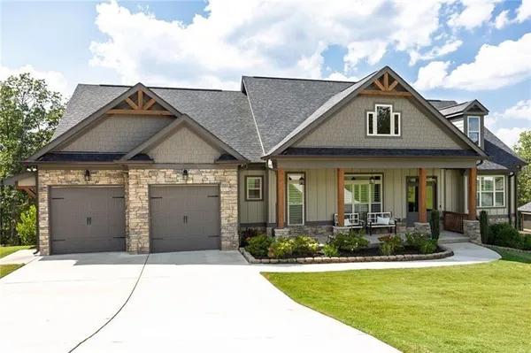 a front view of a house with a yard and garage