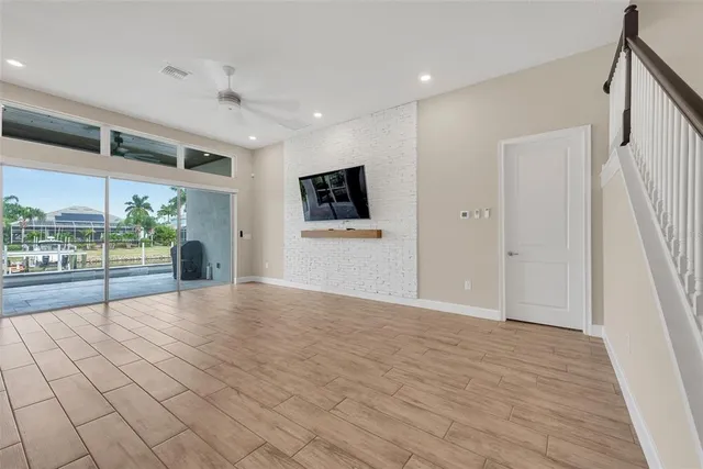 a view of a livingroom with wooden floor and a window
