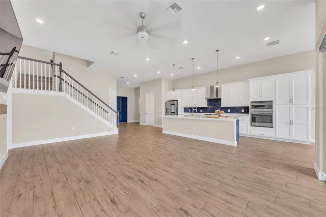 a view of kitchen with cabinets stainless steel appliances with wooden floor