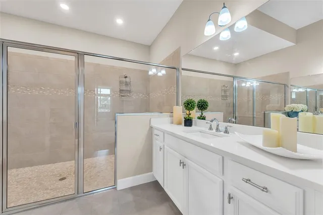 a bathroom with a shower sink and mirror
