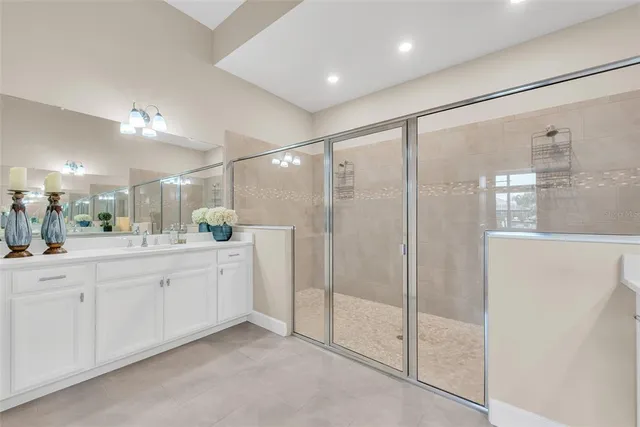 a bathroom with a double vanity sink and mirror
