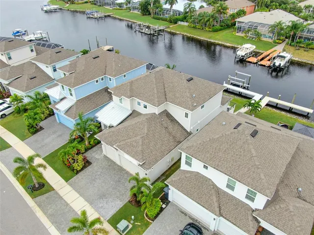 an aerial view of a pool with chairs