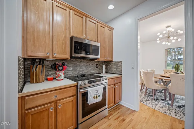 a kitchen with a stove a sink and a microwave