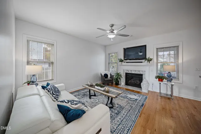 a living room with furniture a fireplace and a flat screen tv