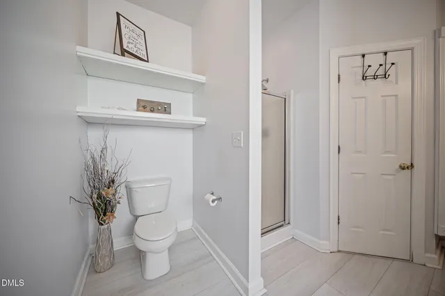 a white toilet sitting next to a bathroom sink