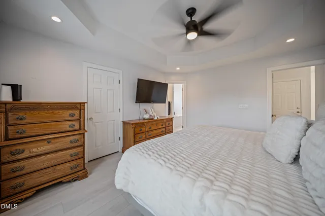a bedroom with a bed mirror and window