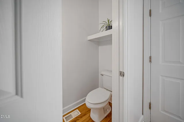a living room with patio furniture and a potted plant