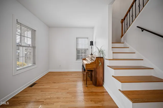 a view of entryway and hall with wooden floor