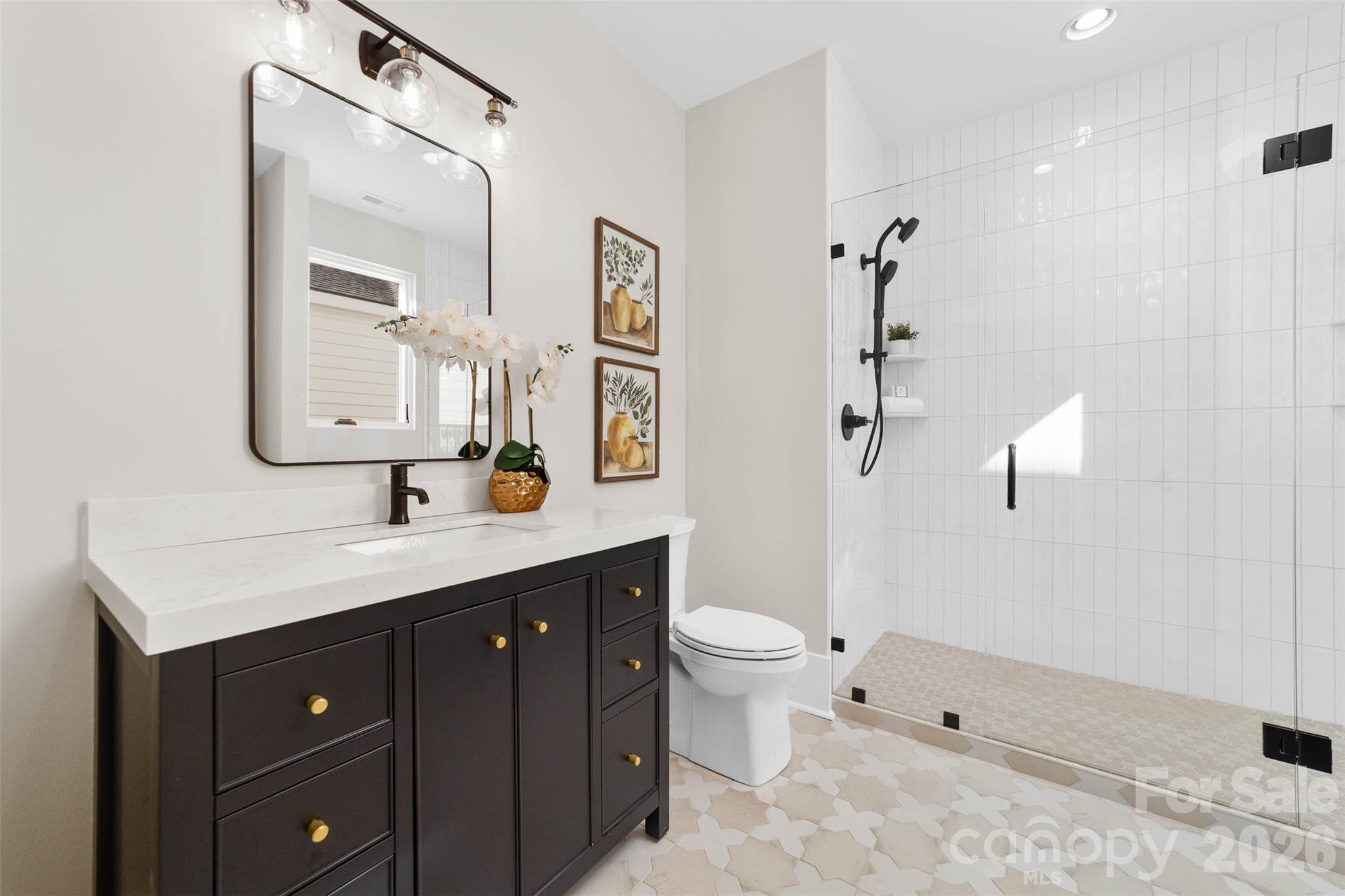 216 Walnut Street Davidson, NC 28036 - Photo 36 of 48 a bathroom with a toilet a sink a mirror a bathtub and vanity