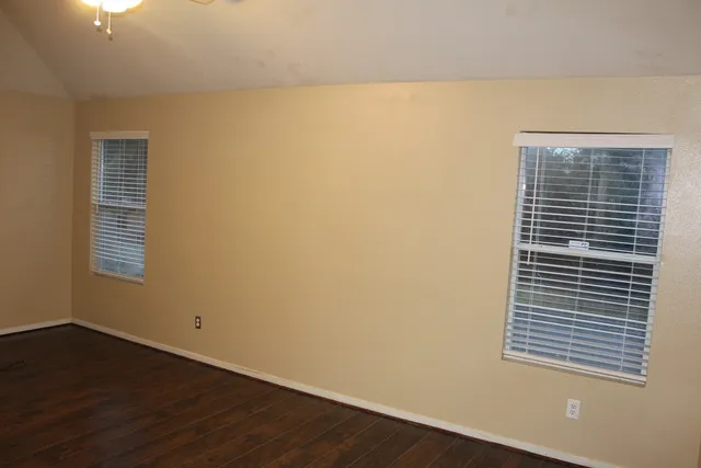 a view of a small space with wooden floor and a window
