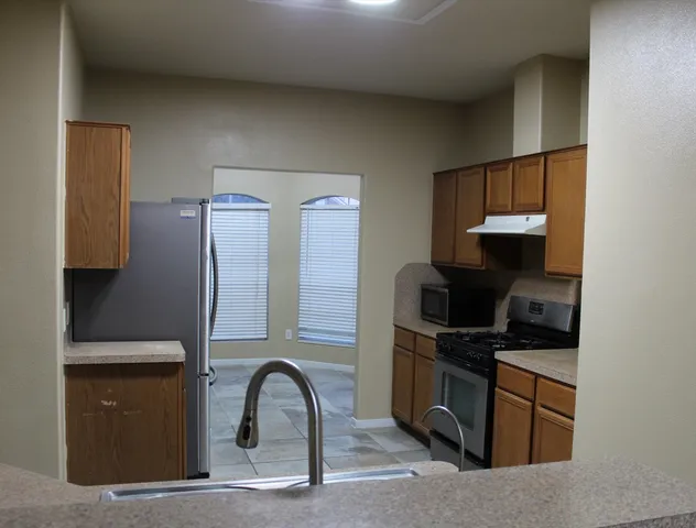 a kitchen with a sink and a stove top oven