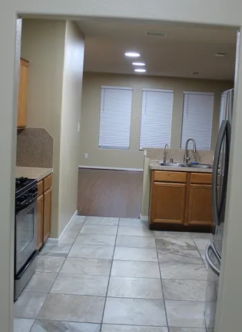 a kitchen with stainless steel appliances a stove a sink and a refrigerator