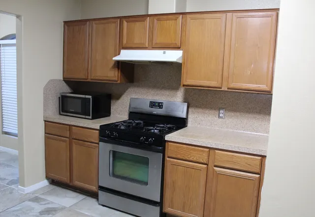 a kitchen with a stove and a microwave