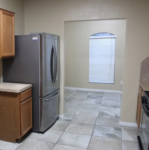 a metallic refrigerator freezer sitting in a kitchen